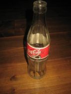 Flaske uten innhold, COCA COLA, noen år tilbake i tid.
