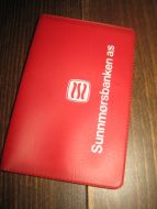 Plastomslag med timeplan, fra SUNNMØRSBANKEN. 60-70 tallet.